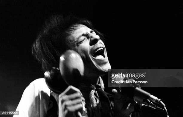 Photo of Arthur LEE and LOVE; Arthur Lee performing live onstage, playing maracas