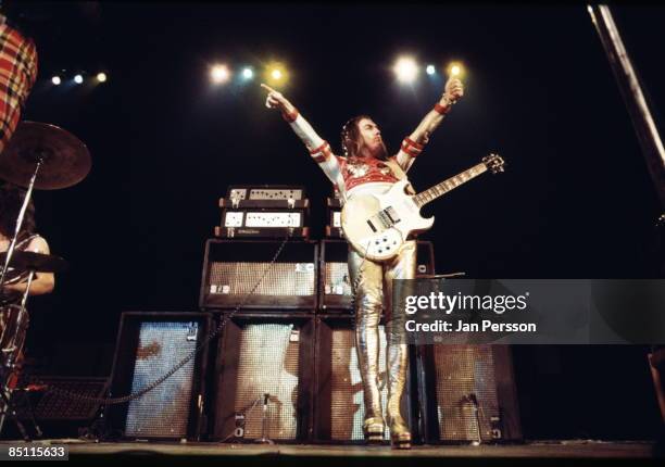 Photo of Dave HILL and SLADE; Dave Hill performing live onstage with Slade, wearing silver boots