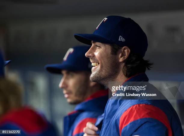 Cole Hamels of the Texas Rangers smiles in the dugout after closing out the eighth inning against the Seattle Mariners at Safeco Field on September...