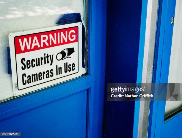 video surveillance sign on window - washington state sign stock pictures, royalty-free photos & images