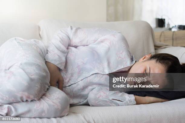 young adult woman holding her crotch - pelvis stock pictures, royalty-free photos & images