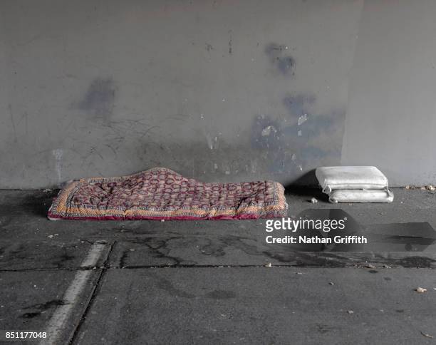 homeless person's bed and pillows under bridge - homeless person imagens e fotografias de stock