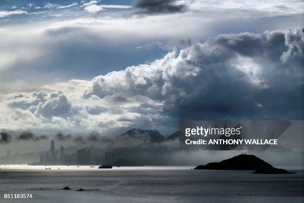 General view shows clouds above Hong Kong island early on September 22, 2017. - Standard & Poor's on September 22, slashed Hong Kong's top-notch...