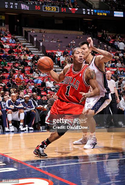 Derrick Rose of the Chicago Bulls drives against Yi Jianlian of the New Jersey Nets during the game on February 25, 2009 at the Izod Center in East...