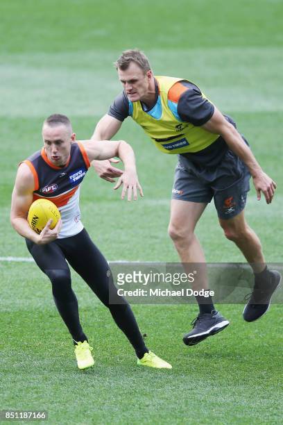 Tom Scully of the Giants pushes off assistant coach Dean Brogan during the Greater Western Sydney Giants AFL training session at Melbourne Cricket...
