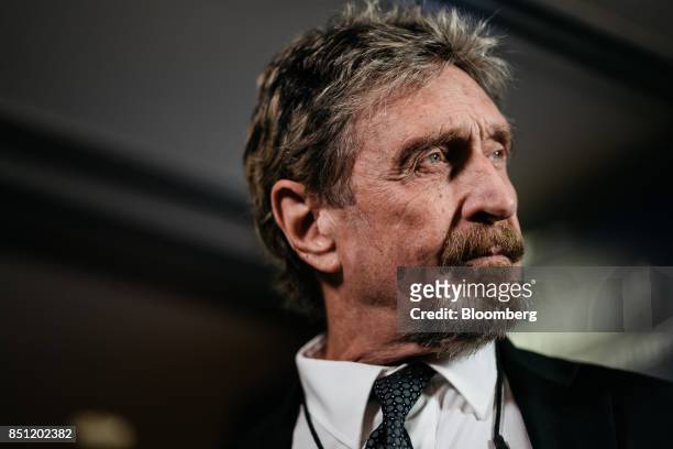 John McAfee, founder of McAfee Associates Inc. And chief cybersecurity visionary at MGT Capital Investments Inc., listens during a Bloomberg...