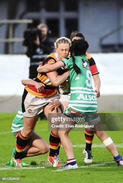 Chelsea Alley of Waikato gets tackled by Corrineke Windle of Manawatu during the round four Farah Palmer Cup match between Manawatu and Waikato at...