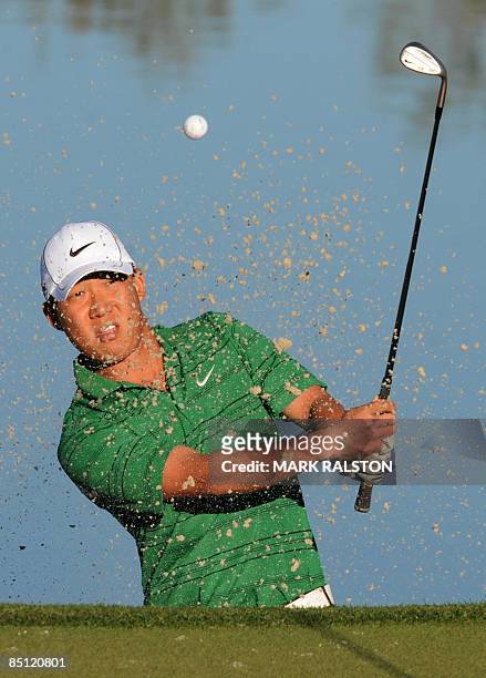 Anthony Kim of the US plays from a sand bunker on the 3rd hole during his matchplay round against Lin Wen-Tang of Taiwan on the first day of the...