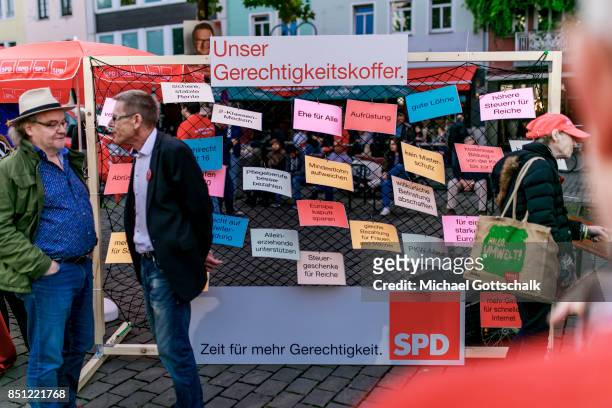 Supporters show their suitcase of fairness or Gerechtigkeitskoffer with their campaign promises during electoral campaign on September 21, 2017 in...