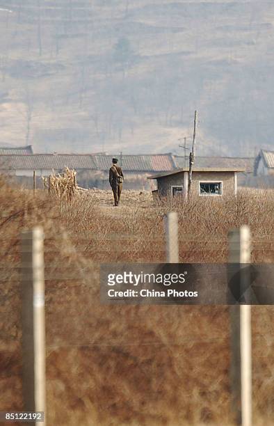 North Korean soldier keeps watch in front of a lookout post on the banks of the Yalu River on February 26, 2009 in Dandong of Liaoning Province,...
