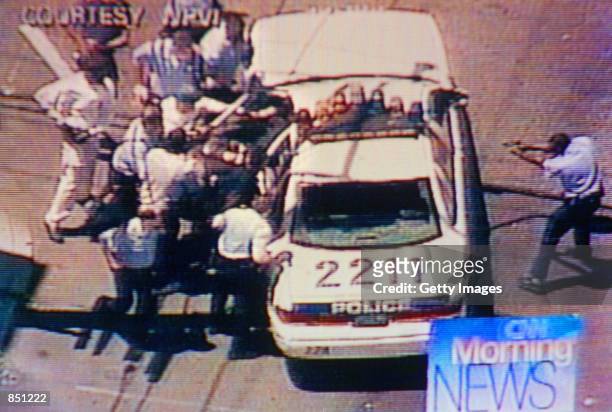 Video still of Philadelphia Police pulling a suspect out of a car and beating him on July 7, 2000 in Philadelphia, PA. The suspect shot at police...