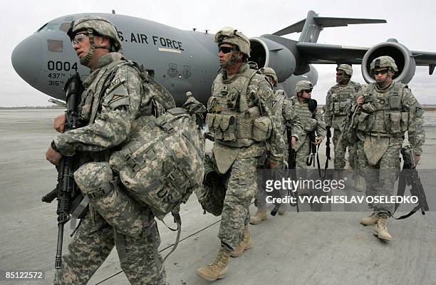 Soldiers arrived from Afghanistan walk outside a plane at the US airbase 30 km outside Bishkek in Manas on February 26, 2009. The soldiers who had...