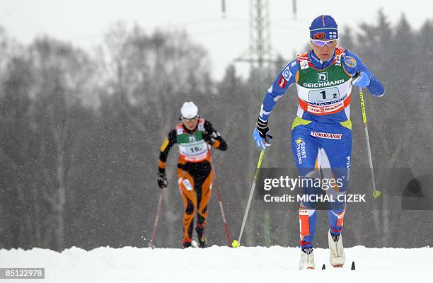 Virpi Kuitunen of Finland and Kornelia Marek of Poland compete during the women's Relay 4x5 Km Classic/Free event of the Nordic Skiing World...