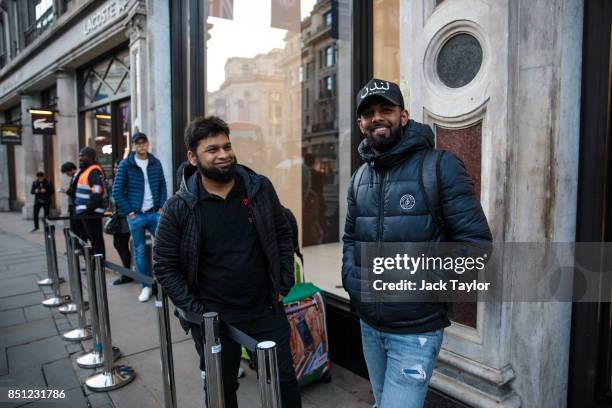 First in line Salam Bin Mohammed from east London, who has been queueing since 10pm last night, poses for a picture outside Apple Regent Street ahead...