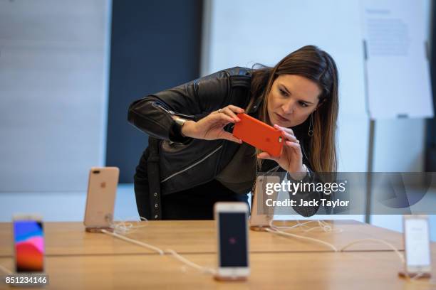 Woman takes a picture of the new iPhone 8 on display at Apple Regent Street during the phone's launch on September 22, 2017 in London, England. Apple...