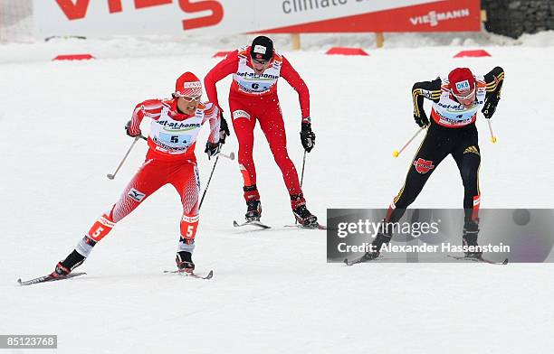 Norihito Kobayashi of Japan, Magnus-H Moan of Norway and Tino Edelmann of Germany power towards the finish line during the 4X5KM Relay competition of...