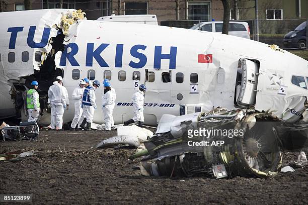 Investigators examine the wreck of a Turkish Airlines Boeing 737-800 passenger aircraft on February 26, 2009 which crashed at Amsterdams' Schiphol...