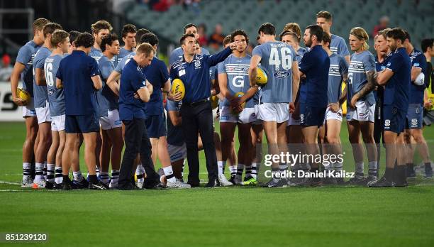 Cats head coach Chris Scott talks to his players in the middle of Adelaide Oval prior to the First AFL Preliminary Final match between the Adelaide...