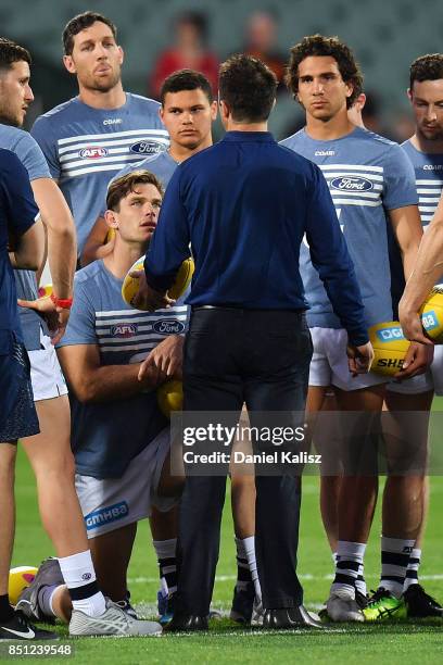 Cats head coach Chris Scott talks to his players as Tom Hawkins of the Cats looks on prior to the First AFL Preliminary Final match between the...