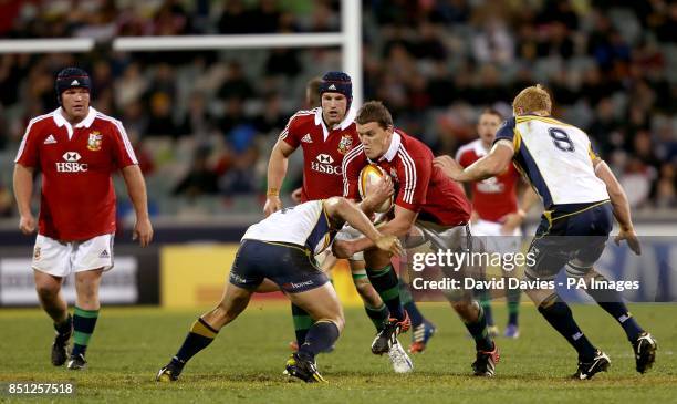 British and Irish Lions' Ian Evans in action with ACT Brumbies' Colby Faingaa and Peter Kimlin