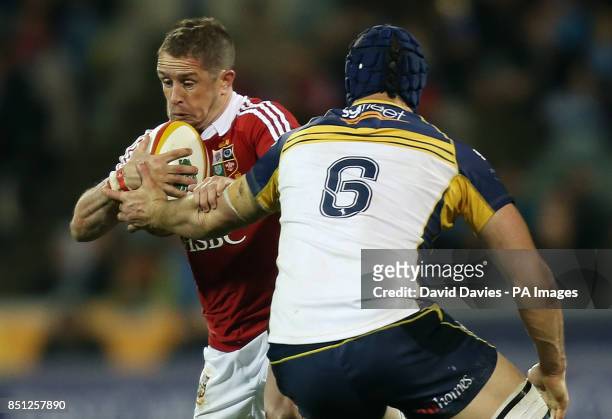 British and Irish Lions' Shane Williams is tackled by ACT Brumbies' Scott Fardy during the International tour match at the Canberra Stadium, Canberra.