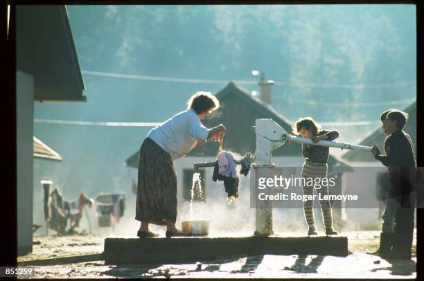 Woman wrings out clothing at a water pump December 1, 1994 in Tuzla, Bosnia-Herzegovina. When Bosnia declared its independence in March of 1992, the...