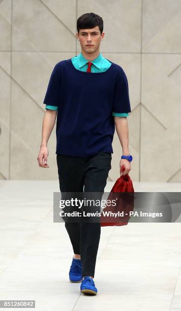 Model on the catwalk at The Burberry Prorsum show at the London Collections: MEN SS14 at Kensington Gardens in London.