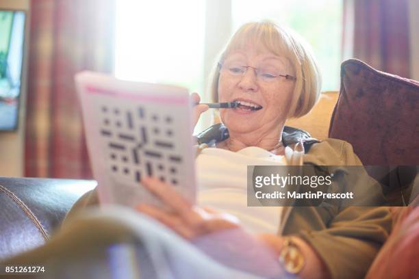 struggling with the answer - crosswords stock pictures, royalty-free photos & images