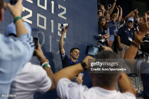 Captain Matt Besler paints "2017" on the wall of club honors under the owner's boxas Sporting Kansas City hosted the New York Red Bulls on September...