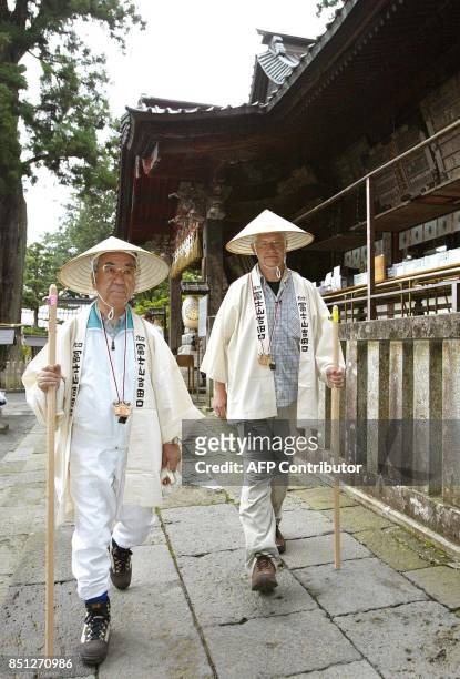 Hartwing Gauder , former German Olympic champion, and Fujiyoshida city mayor Toshio Kayanuma depart Fuji Sengen Shrine in Fujiyoshida, Yamanashi...