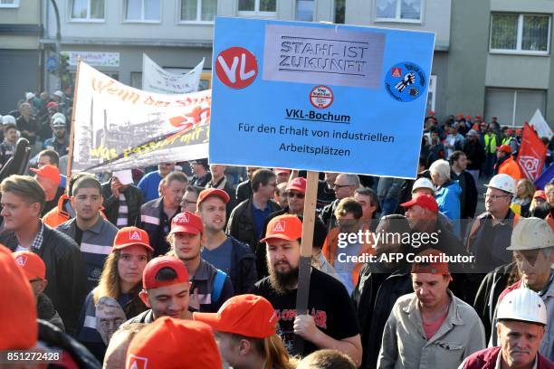 Steelworkers of the ThyssenKrupp Steel Europe hold a poster reading 'Steel is Future' during a protest against fusion contract between ThyssenKrupp...