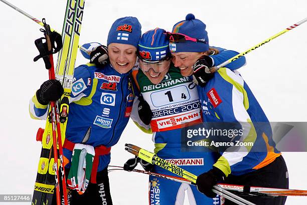Pirjo Muranen, Aino Kaisa Saarinen and Virpi kuitunen of Finland celebrate 1st place during the FIS Nordic World Ski Championships Cross Country...