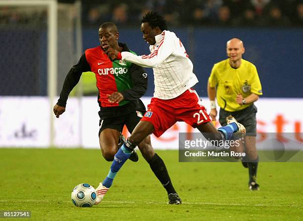 Jonathan Pitroipa of Hamburg and Dominique Kivuvu of Nijmegen battle for the ball during the UEFA Cup Round of 32 second leg match between Hamburger...