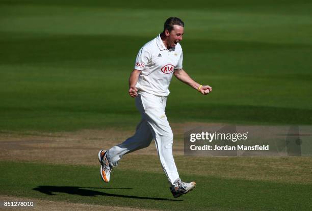 Rikki Clarke of Surrey celebrates dismissing Tom Abell of Somerset during day four of the Specsavers County Championship Division One match between...