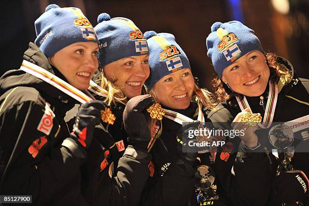 Pirko Muranen, Virpi Kuitunen, Riitta-Liisa Roponen and Aino Kaisa Saarinen of Finland celebrate with their gold during the medal ceremony after the...