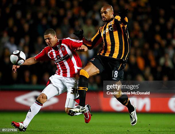 Caleb Folan of Hull battles with Kyle Walker of Sheffield United during the FA Cup sponsored by E.on 5th round replay match between Hull City and...