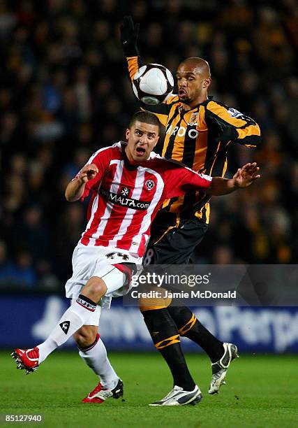 Caleb Folan of Hull battles with Kyle Walker of Sheffield United during the FA Cup sponsored by E.on, 5th round replay match between Hull City and...
