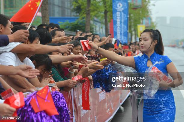 The Tour hostess distributes gadgets to the members of the public ahead of the start to the fourth stage of the 2017 Tour of China 2, the 115.3km...