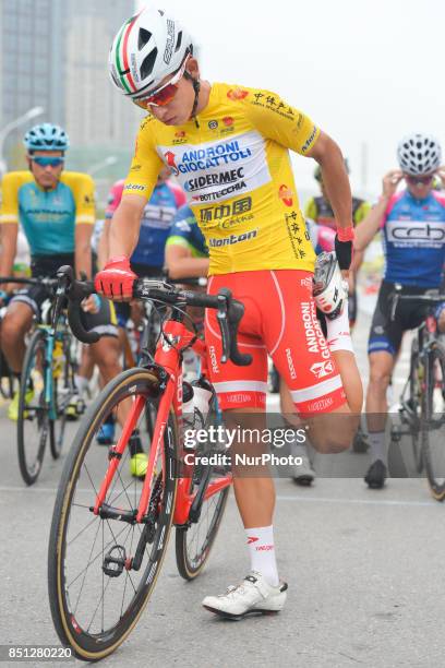 The Yellow Jersey, Kevin Rivera Serrano from Androni Sidermec Bottecchia team, stretches his legs before the start to the fourth stage of the 2017...