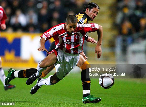Peter Halmosi of Hull battles with Kyle Naughton of Sheffield United during the FA Cup sponsored by E.on 5th round replay match between Hull City and...