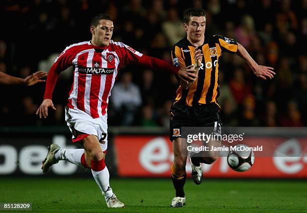 Ryan France of Hull battles with Billy Sharp of Sheffield United during the FA Cup sponsored by E.on, 5th round replay match between Hull City and...