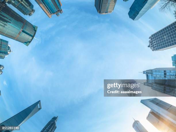 360 degree view of modern skyscrapers against sky - 360 stock-fotos und bilder