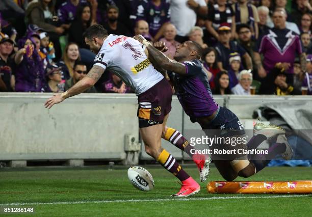 Darius Boyd of the Brisbane Broncos is challenged by Suliasi Vunivalu of the Storm during the NRL Preliminary Final match between the Melbourne Storm...