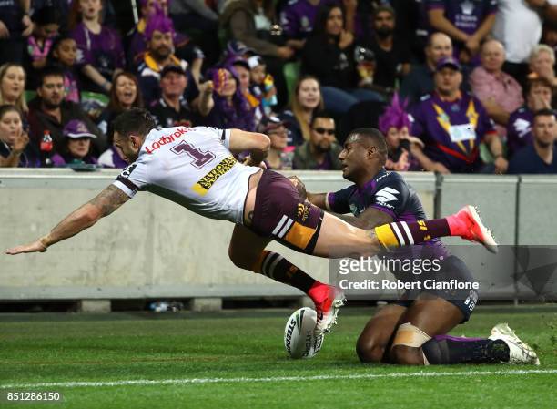 Darius Boyd of the Brisbane Broncos is challenged by Suliasi Vunivalu of the Storm during the NRL Preliminary Final match between the Melbourne Storm...