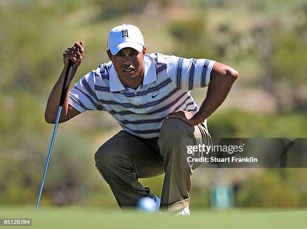 Tiger Woods lines up a putt on the second green during the second round of the Accenture Match Play Championship at the Ritz-Carlton Golf Club at...