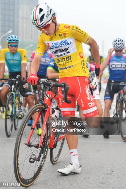 The Yellow Jersey, Kevin Rivera Serrano from Androni Sidermec Bottecchia team, stretches his legs before the start to the fourth stage of the 2017...