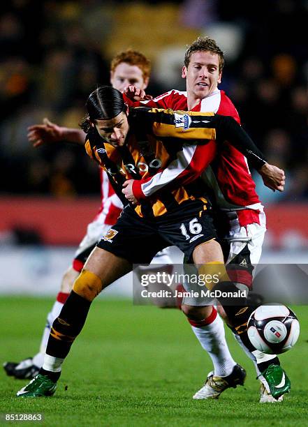 Peter Halmosi of Hull battles with Brian Howard of Sheffield United during the FA Cup sponsored by E.on, 5th round replay match between Hull City and...