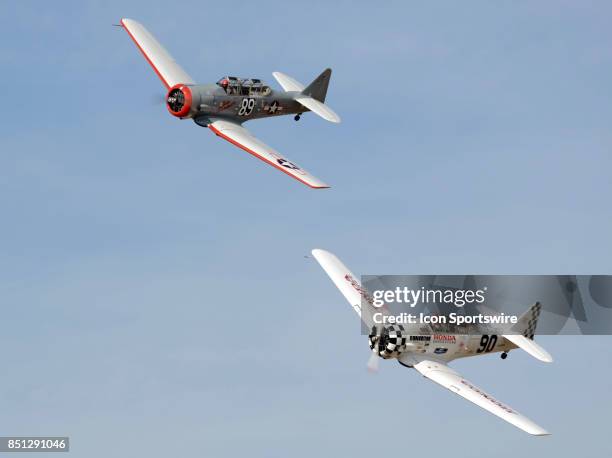 Gene McNeely pilot of the AT-6 "Baby Boomer" and Greg McNeely pilot of T-6G "Undecided" head for the pylon in the Heat 2A race at the 54th National...