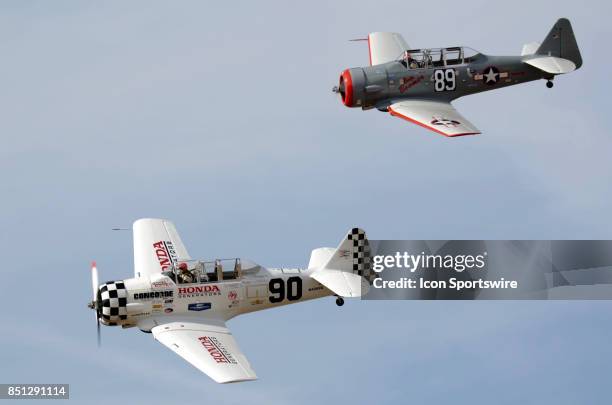 Greg McNeely pilot of the T-6G "Undecided" leads Gene McNeely pilot of the AT-6 "Baby Boomer" in the T-6 Heat 2A race at the 54th National...