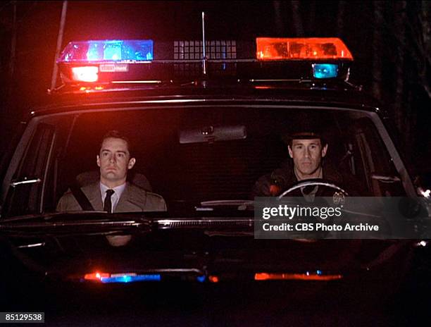 In a scene from the pilot episode, Kyle MacLachlan as Special Agent Dale Cooper sits with Michael Ontkean as Sheriff Harry S. Truman as they...